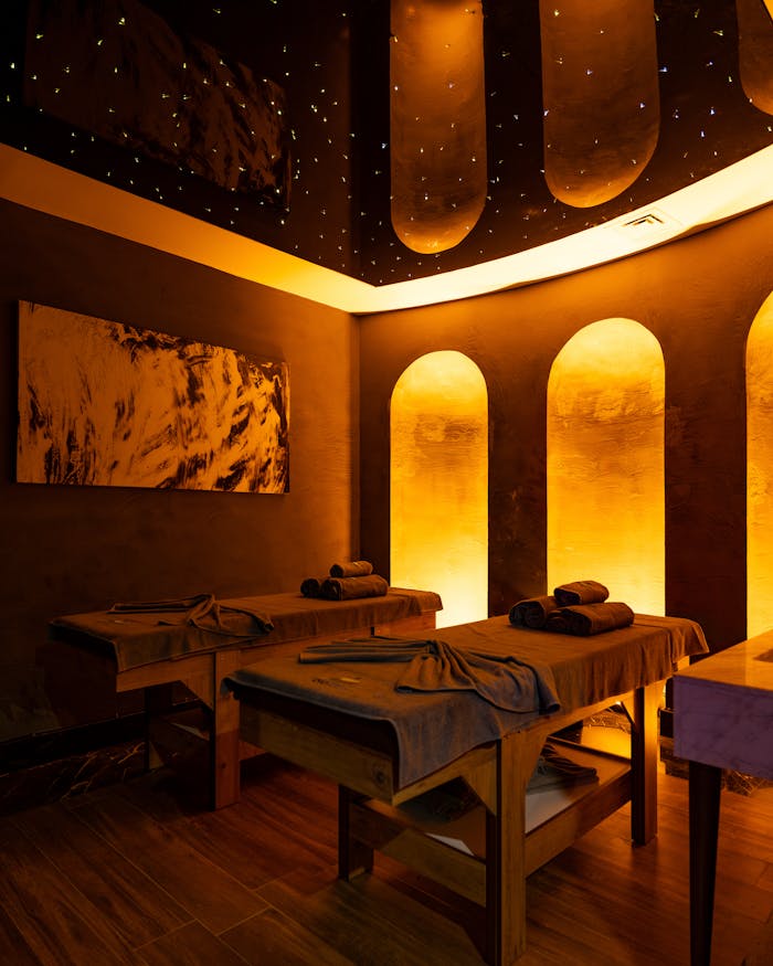 hero-img-02 Relaxing spa interior with ambient lighting in Bodrum, Türkiye, showcasing massage tables and decor.